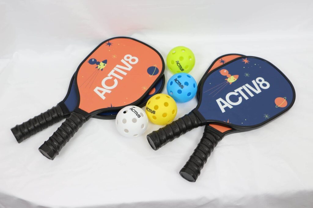 Two colorful Activate pickleball paddles and pickleballs designed for fun and engaging recess activities. Explore more ideas for recess using high-quality sports equipment.